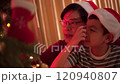 Happy cheerful Asian family celebrating Christmas and New Year dinner party together, a family with father and son. Asian lovely family celebrate Christmas - New Year festival. 120940807