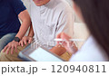 Senior Asian man having an annual health check by doctor. A female doctor comes to see a senior adult patient at home and checks his heart health and blood pressure. Doctor visiting elder patient's ho 120940811