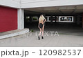 slow motion from a blond woman with short sexy black dress walking view from behind 120982537