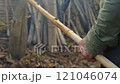 Engaging in the art of crafting with Bamboo amidst beautiful natural surroundings in nature 121046074