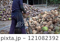 Coconut Cutting with a Traditional Knife: Tropical Market Scene 121082392