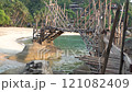 A Rustic Bamboo Bridge Gracefully Arching Over Crystal Clear Waters in a Serene Setting. Haad Sadet Beach, Koh Phangan island, Thailand 121082409