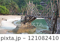 A Rustic Bamboo Bridge Gracefully Arching Over Crystal Clear Waters in a Serene Setting. Haad Sadet Beach, Koh Phangan island, Thailand 121082410