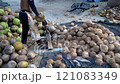 Coconut Cutting with a Traditional Knife: Tropical Market Scene 121083349