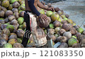 Coconut Cutting with a Traditional Knife: Tropical Market Scene 121083350