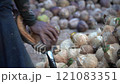 Coconut Cutting with a Traditional Knife: Tropical Market Scene 121083351
