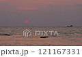 A boat at sunset in a calm sea with gentle waves near the shore A boat at sunset in a calm sea with gentle waves near the shore 121167331