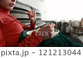 Woman eating snacks watching tv in slow motion. Young hispanic 121213044