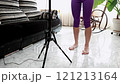 Young woman perfecting her salsa dance steps in a lively living room setting. Latin woman 121213164