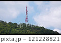 Time lapse Directional antenna array on a red and white communication tower against sky. 121228821