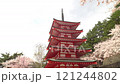 Red five-story pagoda with copy space and falling cherry blossom petals, Arakurayama Sengen Park in spring, fixed shot 121244802
