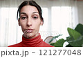 Young latina gen z woman expressing surprise emotion by raising eyebrows in slow motion 121277048