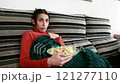 Frightened Woman watching scary movie in slow motion. Young hispanic 121277110