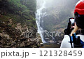 Capturing the Beauty of a Majestic Waterfall Nestled in a Misty and Enchanting Landscape 121328459