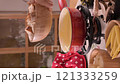 Cozy Swiss fondue setup with melted cheese, bread, pickles, and wine on a rustic table. advertising 121333259