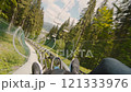 POV view a man in moving action unrecognizable man going down a mountain roller down a track, outdoor adventure in the mountains Europe 4K UHD B-Roll footage 121333976