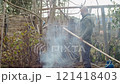 Woodworker working on bamboo outdoors 121418403