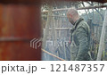 A woodworker working bamboo with fire in a rustic outdoor setting that feels authentic 121487357
