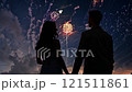 Couple is holding hands while watching fireworks 121511861