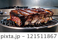 Rack of ribs is being cooked on a grill 121511867