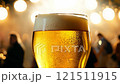 Glass of beer is sitting on a table in a bar 121511915