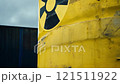 Yellow container with a black X on it 121511922