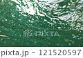 Air bubbles underwater rise to the surface of the sea 121520597