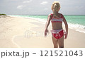 Happy child girl 5 years old running on sea beach with white sand on sunny day 121521043