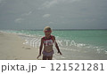Happy child girl 5 years old running on the sea beach on a sunny day 121521281
