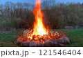 Bonfire burning brightly at dusk 121546404