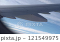 Top bird eye View from passenger porthole of beautiful landscape Flying airplane engine wing of plane fly on sunny cloudy day in winter. Transport, tourism, travel, flight, holidays vacation concept. 121549975