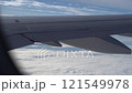 Top bird eye View from passenger porthole of beautiful landscape Flying airplane engine wing of plane fly on sunny cloudy day in winter. Transport, tourism, travel, flight, holidays vacation concept. 121549978