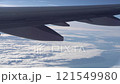 Top bird eye View from passenger porthole of beautiful landscape Flying airplane engine wing of plane fly on sunny cloudy day in winter. Transport, tourism, travel, flight, holidays vacation concept. 121549980