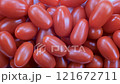 Top down view. Close-up, heap of fresh small tomatoes in close detail. Natural red tones and textured skins. Slider shot. Food, nutrition, vegetables, snacks, ingredient concepts. 4k 121672711