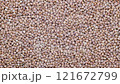 Top down view. Heap of uncooked dry buckwheat groats. Grechka.  Slider shot. Depth of field, selective focus. Texture of grains. Cooking, whole grains, traditional cuisine, food related concepts. 4k 121672799