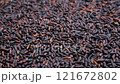 Heap of uncooked dry black rice. Raw black wild rice. Slider shot. Depth of field, selective focus. Texture of grains. Cooking, whole grains, traditional cuisine, food related concepts. 4k 121672802