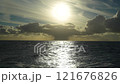 Big cloud over sea. Sunset over the ocean with dramatic clouds and reflective water creating a serene atmosphere 121676826