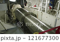 Motor room of ship. Main shaft rotates. Shaft from engine to propeller 121677300