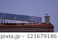Solar panels installed above the tiled roof. Ventilation pipe with rotating nozzle. Solar energy concept. Pula, Croatia - January 3, 2025 121679186