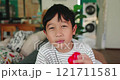 Asian boy looks at camera smiles happily and holds a red heart in his hand. Kid is in love on Valentine's Day. send love to everyone. Concept of love, Valentine, Mother's Day, emotion, and therapy. 121711581