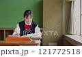 Female junior high school student studying in the classroom 121772518