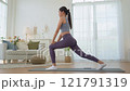 Young Asian woman in sportswear doing yoga in her home or house for health, sports and wellness, Enjoying Domestic Fitness Training And Healthy Lifestyle, Dressed In Stylish Sportswear And Smiling 121791319