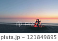 Bonfire on the Beach against a Calm Sea or Ocean at Romantic Evening 121849895