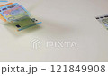 Colored Euro Cash Falling Down on White Table 121849908