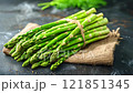 Bunch of asparagus sprouts on burlap on table 121851345