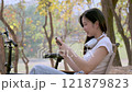 Cute girl enjoying a relaxing time in the park. 121879823