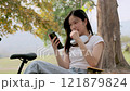 Cute girl enjoying a relaxing time in the park. 121879824