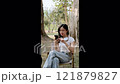 Cute girl enjoying a relaxing time in the park. 121879827