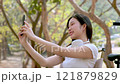Cute girl enjoying a relaxing time in the park. 121879829