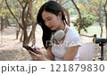 Cute girl enjoying a relaxing time in the park. 121879830